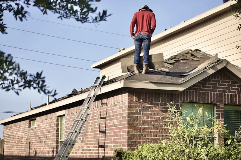 Professional roofer working on a residential roof in West Milford